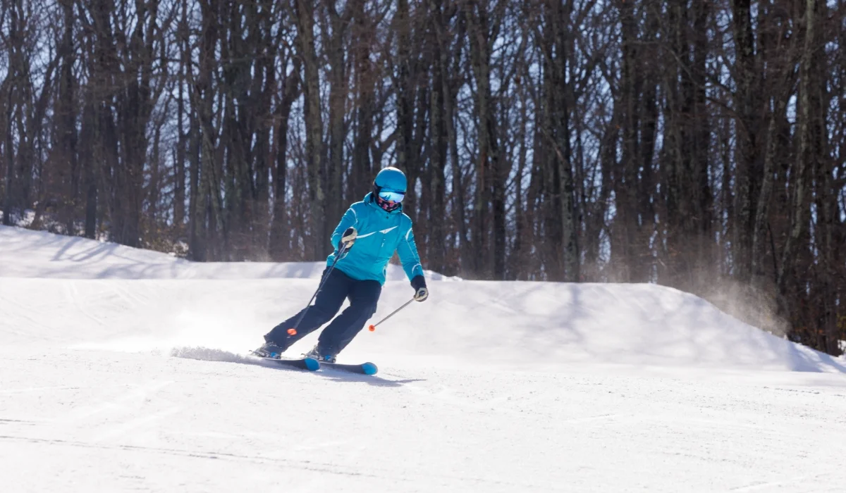 woman in light blue jacket skiing