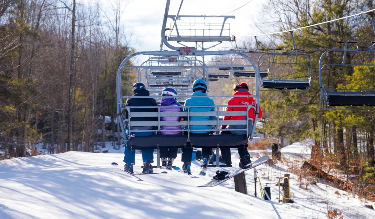 family of 4 on chair lift