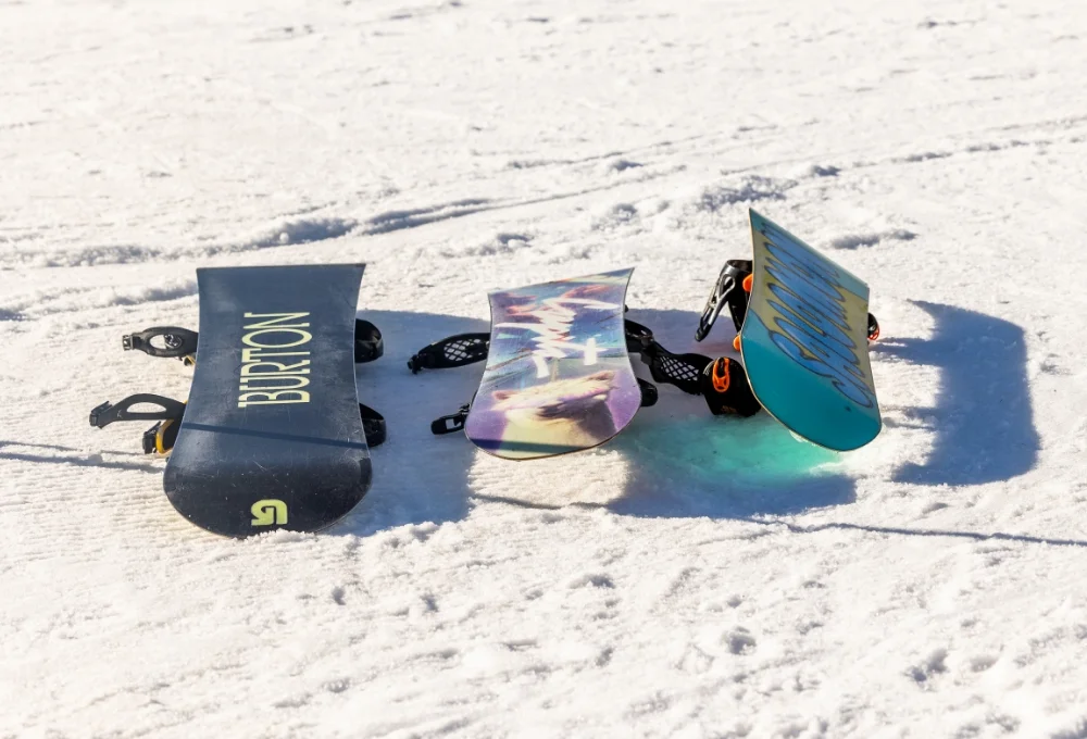 3 snowboards on the snow