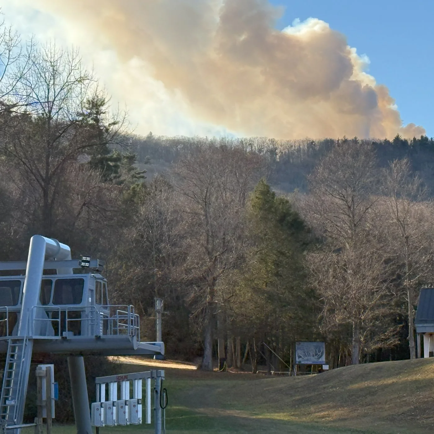 view of wildfire smoke over mountain