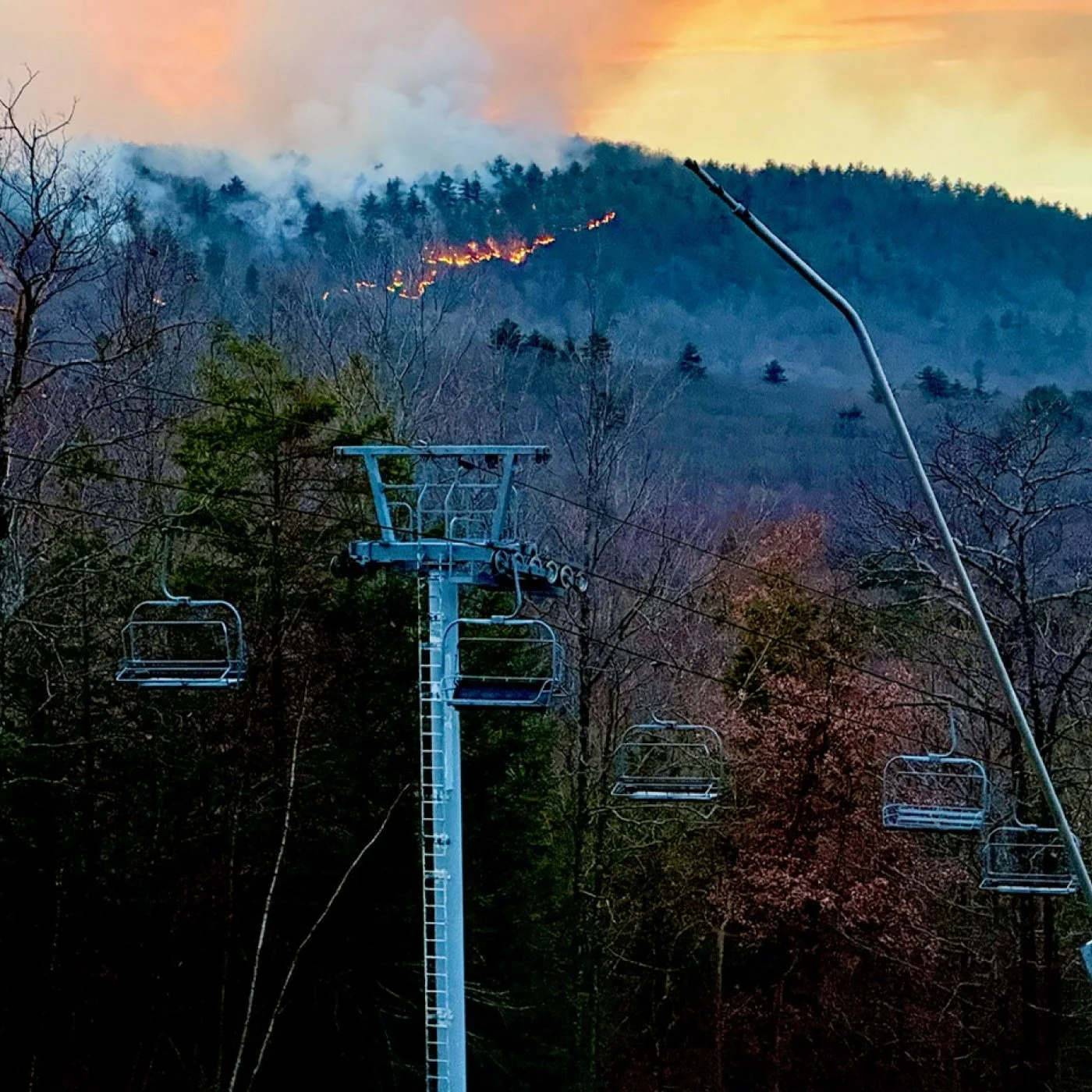 fire line on the mountain behind ski lift